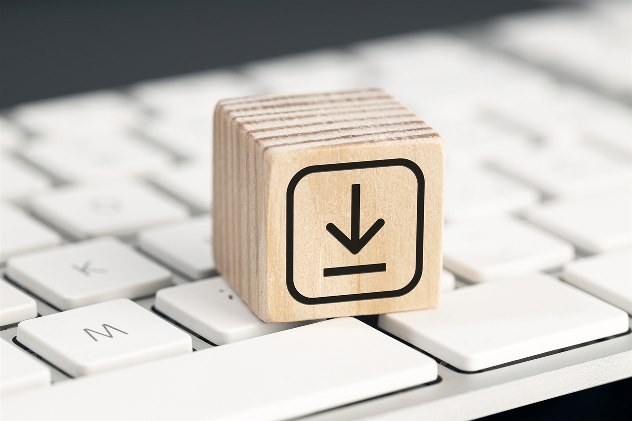 A wooden block on a keyboard with a download icon