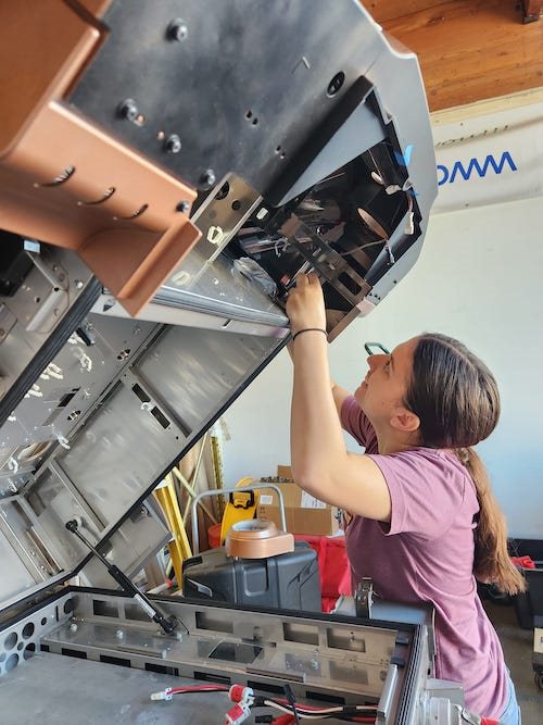 The author's daughter peers inside a large machine.