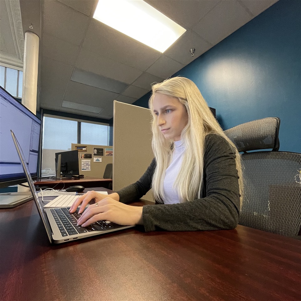 Sarah Hope coding at her desk in Cadence Fort Worth office