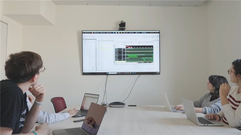 People looking at a screen in a conference room